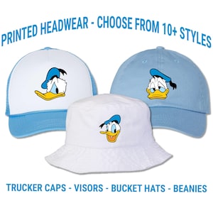 May include: Three hats featuring a Donald Duck graphic. The hats include a white trucker cap, a white bucket hat, and a light blue baseball cap. The image includes the text "PRINTED HEADWEAR - CHOOSE FROM 10+ STYLES" and "TRUCKER CAPS - VISORS - BUCKET HATS - BEANIES".