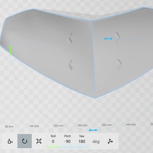 May include: A 3D model of a heart-shaped object with a blue outline. The model is shown on a grid with measurements in millimeters. The model is rotated 180 degrees on the yaw axis and 90 degrees on the pitch axis.