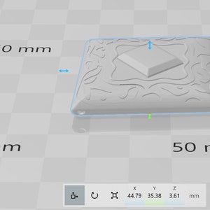 May include: A white, square-shaped pendant with a raised, diamond-shaped design in the center. The pendant has a textured, intricate pattern around the edges. The pendant measures 50 mm by 50 mm.