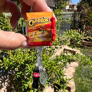 Hot Cheetos Badge Reel with soda