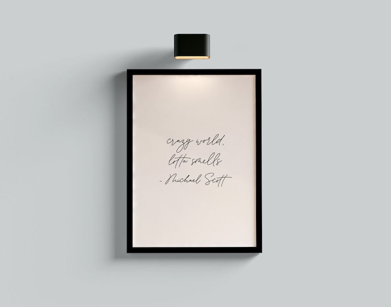 May include: A black framed print with a white background and black text that reads "crazy world. lotta smells - Michael Scott".