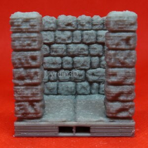 May include: A gray 3D printed miniature stone wall with a textured surface. The wall is made up of small, rectangular bricks. The wall is designed for use in tabletop games and role-playing games.