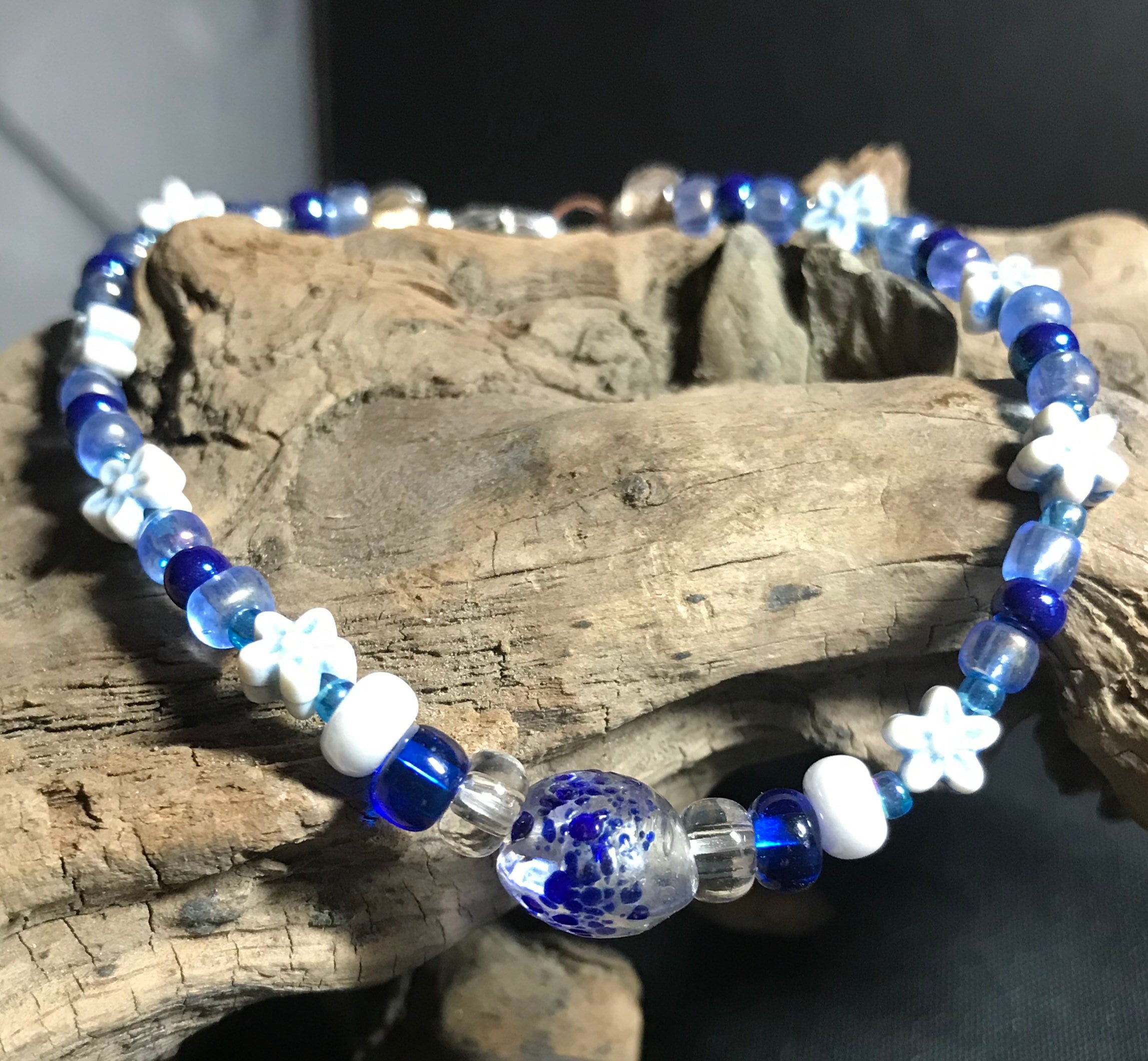 8” pretty blue flowers and clear center bead with blue specks bracelet