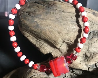 7.25” red and white bracelet with red glass  center bead