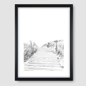 May include: Black and white sketch of a wooden walkway leading to a beach. The walkway is lined with tall grass on either side.