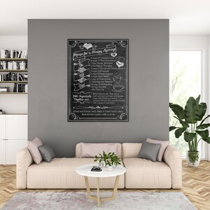 May include: A black chalkboard with white chalk writing that reads "Recipe for a Happy Marriage". The recipe lists ingredients such as "1 cup of Genuine Love", "1 cup of Tender Affection", "1 cup of Forgiveness", "1 cup of Mutual Respect", and "1 cup of Understanding". The chalkboard is hanging on a gray wall in a living room setting.