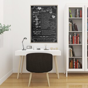 May include: A black chalkboard with a white inscription that reads "Recipe for a Happy Marriage". The inscription lists ingredients for a happy marriage, such as "1 cup of Genuine Love", "1 cup of Tender Affection", and "1 cup of True Commitment". The chalkboard is framed in a light wood frame and is hanging on a white wall in a home office.