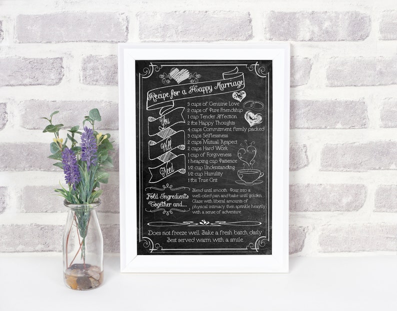 May include: A black and white chalkboard sign with a recipe for a happy marriage. The recipe includes ingredients like genuine love, pure friendship, tender affection, happy thoughts, commitment, selflessness, mutual respect, hard work, forgiveness, patience, understanding, humility, and the true grit. The sign is framed in a white frame.
