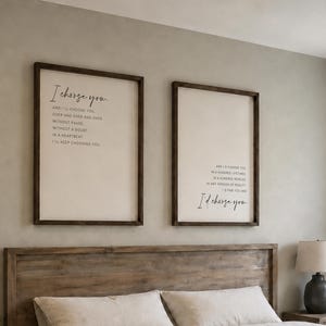 Pu&ograve; includere: Due insegne da parete rettangolari con cornici in legno scuro e sfondi color crema, con testo stampato in nero. L'insegna a sinistra recita I choose you, quella a destra I'd choose you. Sono montate sopra una testiera in legno.
