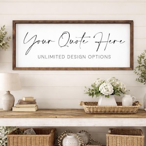 May include: A framed sign with the text "Your Quote Here" in elegant script, and "UNLIMITED DESIGN OPTIONS" below. The frame is dark brown, and the background is white. The sign is displayed above a wooden table with decorative items.
