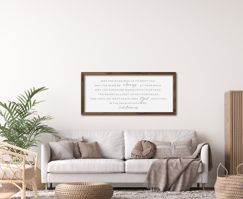May include: A framed wood sign with a white background and black text. The text reads: "May the road rise up to meet you. May the wind be always at your back. May the sun shine warm upon your face. The rains fall soft upon your fields. And until we meet again, may God hold you in the palm of his hand." The text is signed "Irish Blessings".