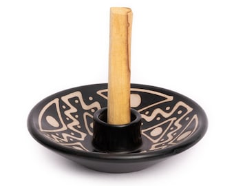 May include: Black ceramic incense holder with a white geometric design and a wooden incense stick.