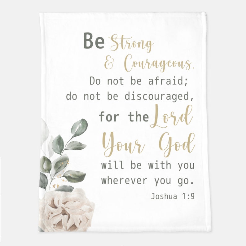 May include: White throw blanket with a floral design and a quote in gold lettering: "Be Strong & Courageous. Do not be afraid; do not be discouraged, for the Lord Your God will be with you wherever you go. Joshua 1:9"