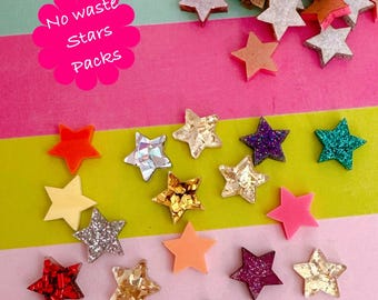 May include: A collection of star-shaped embellishments in various colors and textures, including glitter, iridescent, and solid hues. The image features stars in red, gold, pink, purple, and teal, scattered on a striped background. Text on a pink flower shape reads "No waste Stars Packs."