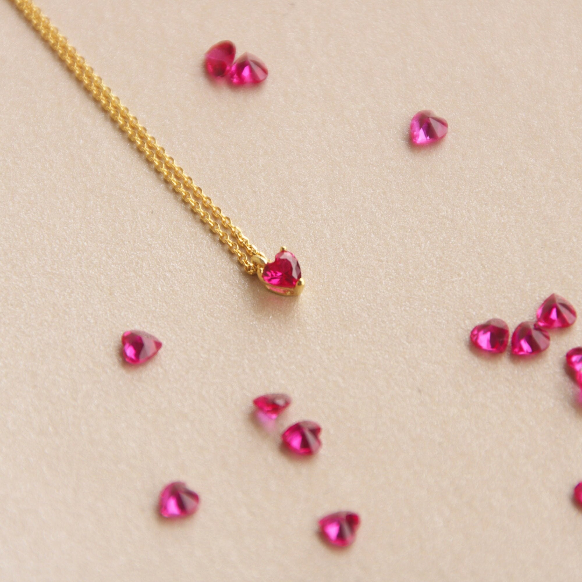 Heart necklace with ruby 2024 in the middle