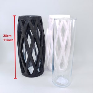 May include: Three decorative vases. One black vase with a diamond lattice design is 11 inches (28 cm) tall. Two additional vases are white and clear glass, also with a diamond lattice design. The vases are suitable for home decor.