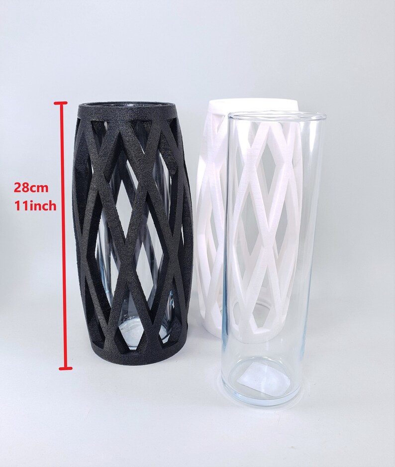 May include: Three decorative vases. One black vase with a diamond lattice design is 11 inches (28 cm) tall. Two additional vases are white and clear glass, also with a diamond lattice design. The vases are suitable for home decor.