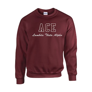 May include: Burgundy sweatshirt with white lettering that reads "ACE Lambda Theta Alpha".