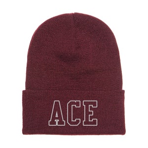 May include: A maroon beanie with a white embroidered "ACE" in a collegiate font.