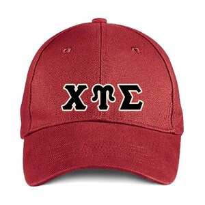 May include: A red baseball cap with a black embroidered Greek letter design that reads "ΧΨΣ".