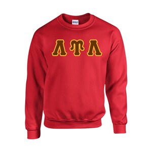 May include: Red sweatshirt with the letters "&Lambda;&Gamma;&Lambda;" in brown with a yellow outline.