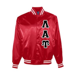 May include: A red satin varsity jacket with white and red striped ribbing around the collar, cuffs, and hem. The jacket has a black embroidered letter design on the back that reads "ΛΑΓ".