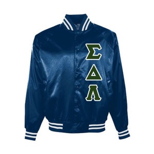 May include: A navy blue satin jacket with white and green accents. The jacket features a button-up front, white stripes on the collar, cuffs, and hem, and green Greek letters on the chest.