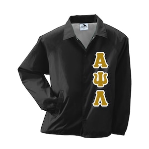 May include: Black coach jacket with a button-up front, collar, and side pockets. The jacket features gold Greek letters A, Ψ, and Λ on the front. The jacket is made of a lightweight material.