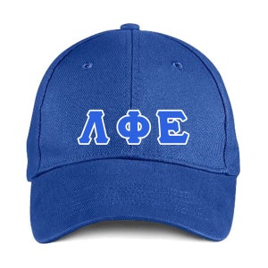 May include: A royal blue baseball cap with white and blue Greek letters. The cap is made of a durable fabric and features a curved brim and an adjustable strap for a comfortable fit. The Greek letters are centered on the front.