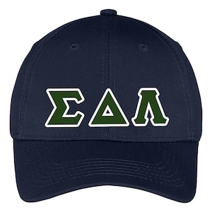 May include: Navy blue baseball cap with the Greek letters ΣΔΛ in dark green with white outlines. The cap has a curved brim and a button on top. The hat is made of a durable fabric.