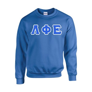 May include: A royal blue sweatshirt with the Greek letters ΛΦΕ in white with blue outlines across the chest. The Gildan brand logo is visible on the collar.
