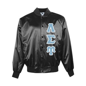 May include: Black satin bomber jacket with light blue Greek letters. The jacket has a button-up front, ribbed cuffs, and a collar. The Greek letters are outlined in white.