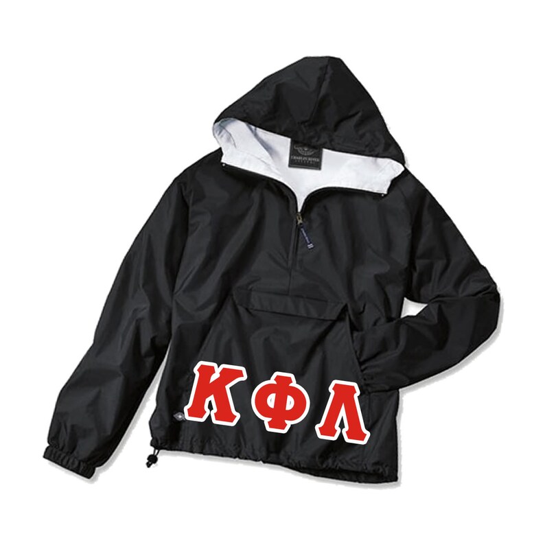 May include: Black hooded anorak jacket with a white interior lining. Features a front pocket and a half-zip closure. The letters "K&Phi;&Lambda;" are displayed in red with a white outline on the lower front of the jacket.