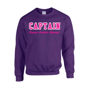May include: Purple sweatshirt with the text "CAPTAIN Sigma Lambda Gamma" in white and pink lettering.