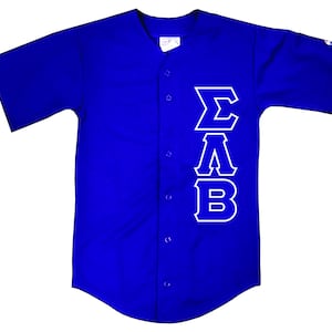 May include: A royal blue baseball jersey with white lettering that reads "ΣΑΒ" down the right side of the jersey.