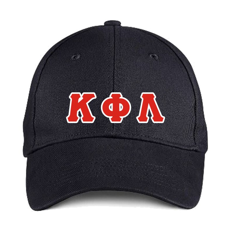 May include: A navy blue baseball cap with the Greek letters &Kappa;&Phi;&Lambda; in red with a white outline. The cap has a curved brim and a button on top.