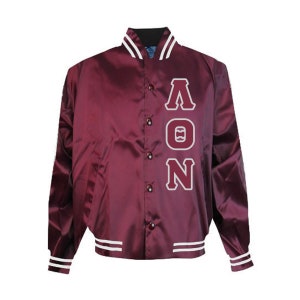 May include: Maroon satin letterman jacket with white trim on the collar, cuffs, and hem. The jacket features the letters AON in white block lettering on the chest. The jacket has a button-up front.