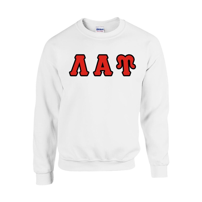 Peut inclure: Sweat-shirt blanc &agrave; col rond avec les lettres "AAT" en rouge bord&eacute;es de noir sur la poitrine. Le sweat-shirt est fait d'une mati&egrave;re douce et poss&egrave;de des manches longues.