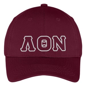 May include: A maroon baseball cap with the letters "AON" in white, outlined in maroon. The cap has a curved brim and a button on top. The letters are in a bold, collegiate style.