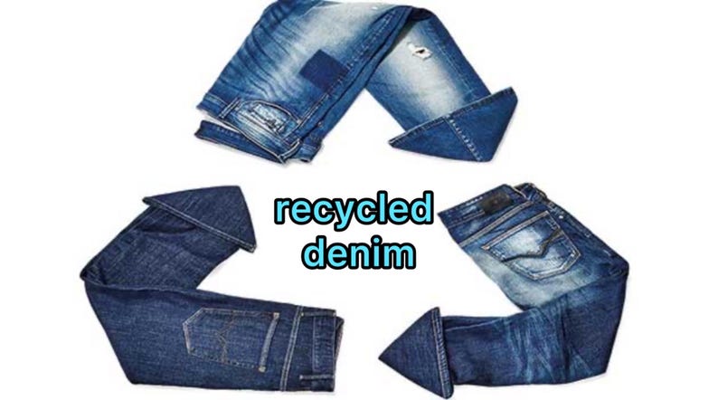 May include: Three pairs of blue denim jeans arranged in a triangular recycling symbol shape. The jeans feature various washes, fading, and distressed details. In the center, the text "recycled denim" is written in blue letters with a light blue outline.