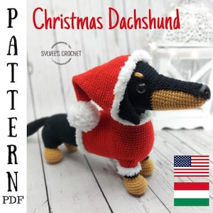 May include: Crochet pattern for a Christmas dachshund wearing a red Santa hat with a white pom-pom. The pattern is available in English, Hungarian, and American English. The text "PATTERN PDF" is written vertically on the left side of the image.