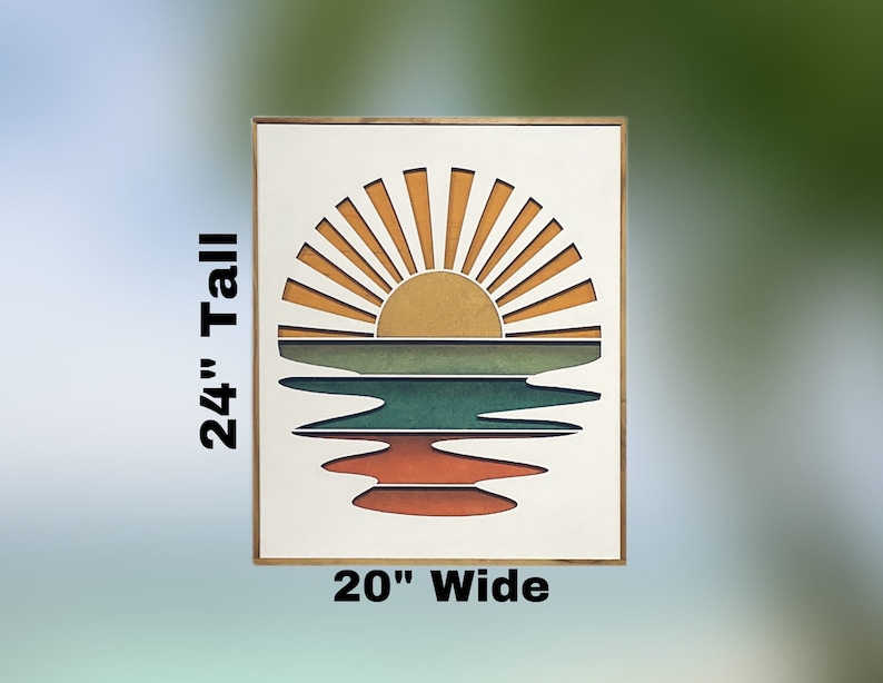 May include: A wooden framed wall art piece with a sunset over a lake design. The sun is yellow with orange rays and the lake is green, blue, and orange. The piece measures 20 inches wide and 24 inches tall.
