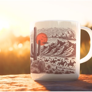 May include: White ceramic mug with a graphic of a desert landscape with a red sun, a cactus, and riders on horseback. The mug has a black handle.