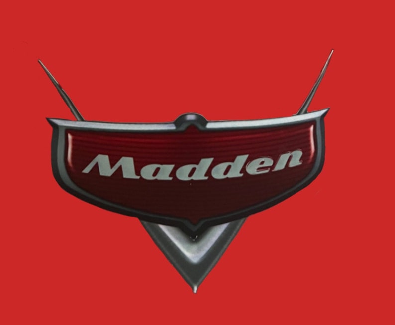 May include: A red and silver car emblem with the word "Madden" in white lettering.