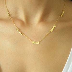 May include: Gold necklace with five name tags, including "Hend", "Hessa", "Shouv", "Saud", and "Ahemed".