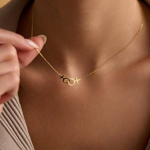 May include: A gold chain necklace with a pendant featuring a circle with a cross on either side.