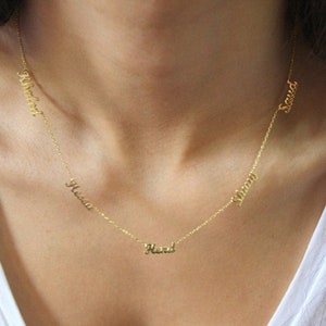 May include: A gold chain necklace with five names on it: "Maxwell", "Hena", "Hend", "Sherry", and "Saud".