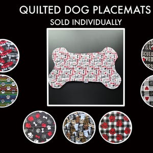 May include: A set of quilted dog placemats in various patterns, including paw prints, bones, and hearts. The placemats are shaped like a bone and are sold individually.