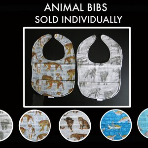 May include: Two baby bibs with animal prints. One features tigers with "Save the Tiger" text, the other elephants with "Save the Elephant" text. The bibs are white with gray and orange accents.
