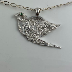 Highly textured Sterling Silver, 925, pendant of a dove with an emerald eye. Unique pattern on silver is highly detailed & steampunk-like!
